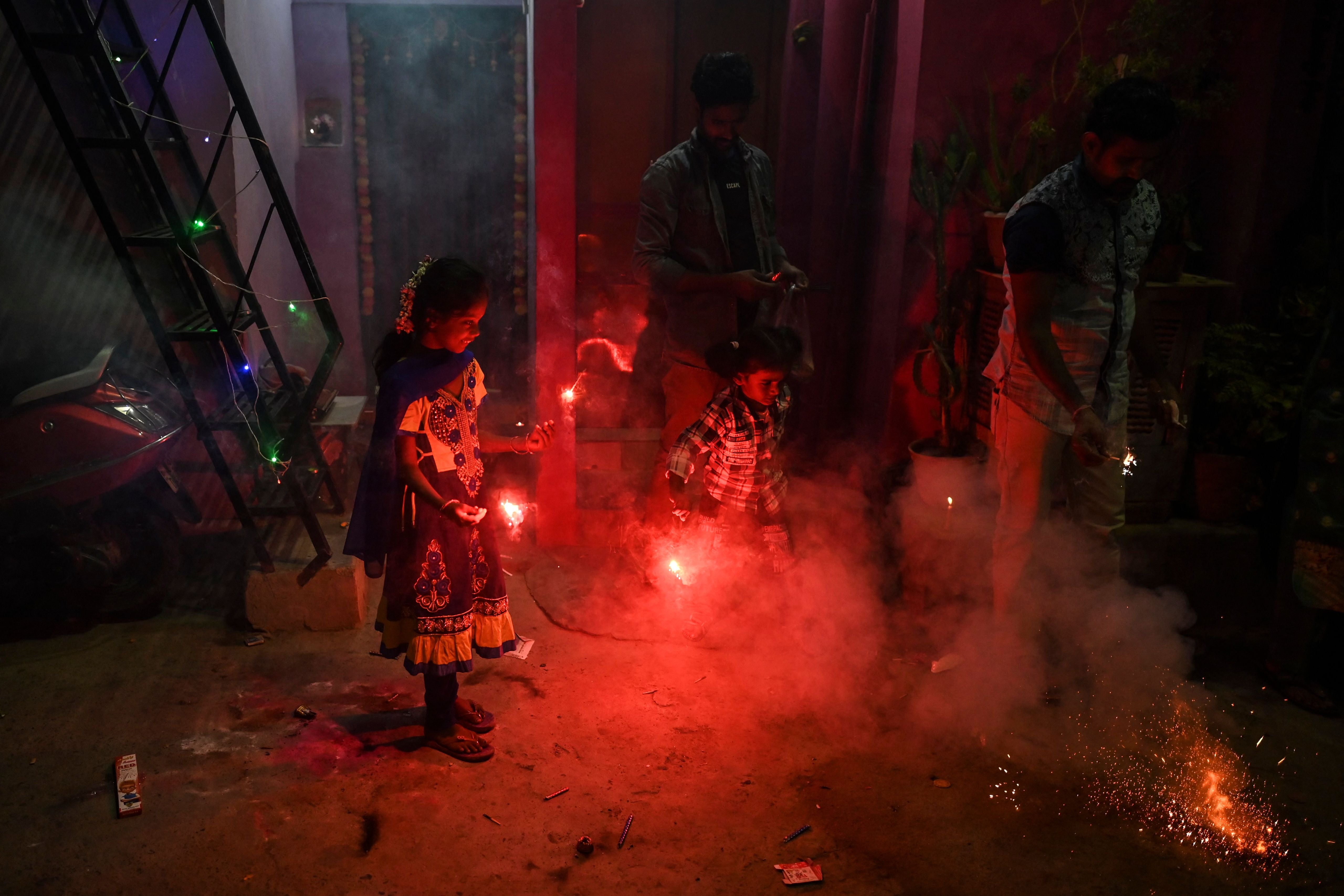 Children play with sparklers as they celebrate the Hindu festival Diwali or the Festival of Lights in New Delhi