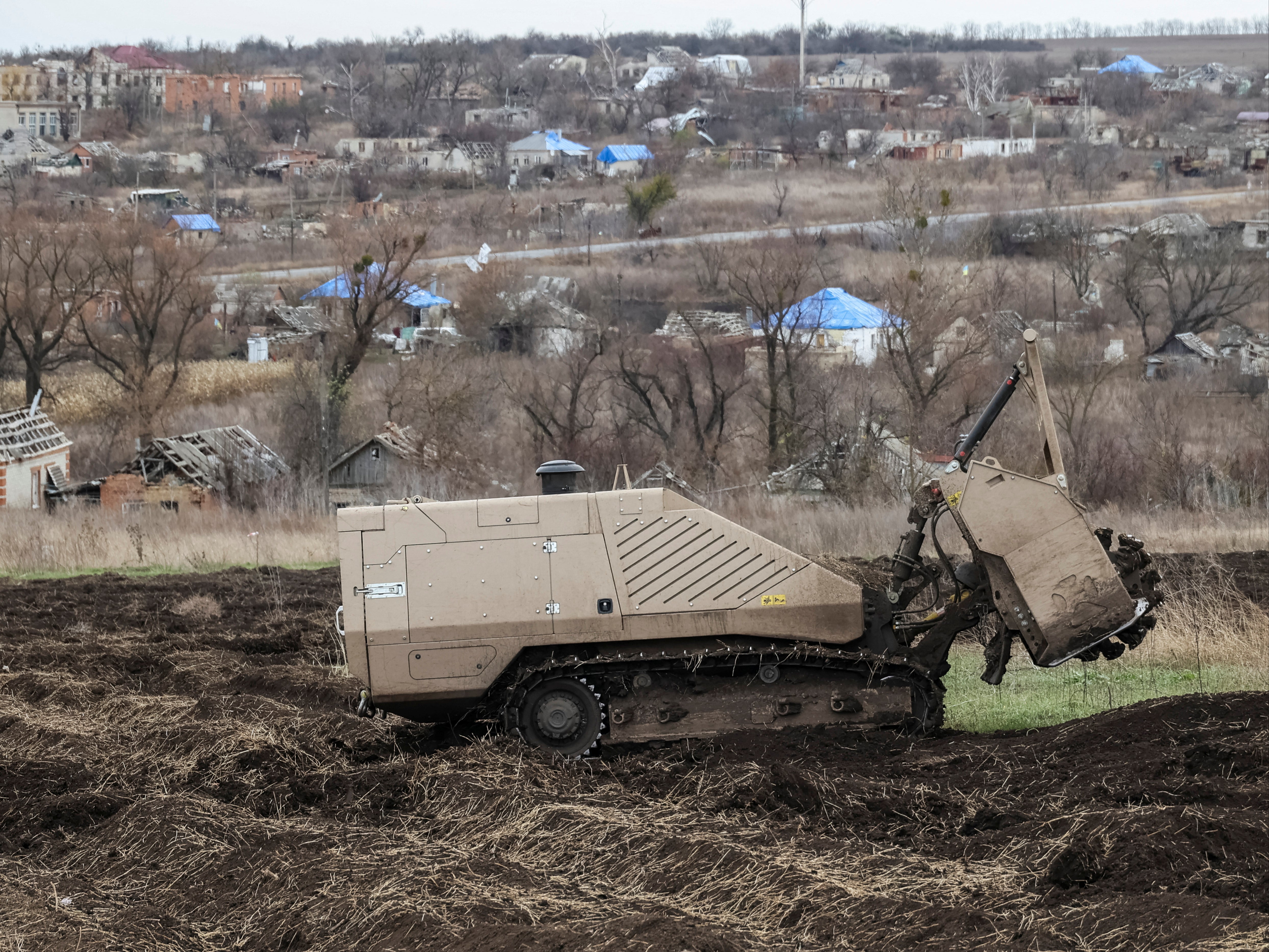 A remote-controlled demining vehicle GCS 200 works on a field near the village of Kamianka in eastern Ukraine