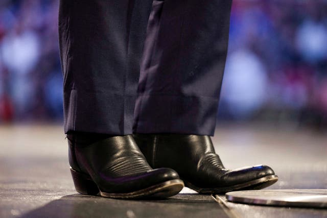 <p>Florida Governor Ron DeSantis, a prospective Republican U.S. presidential candidate in 2024, stands onstage in his standard black cowboy boots as he addresses a university convocation at Liberty University</p>