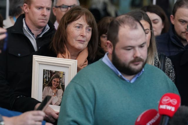 The mother of murdered teacher Ashling Murphy, Kathleen (centre), listens as her son Cathal gives a statement to the media (Brian Lawless/PA)