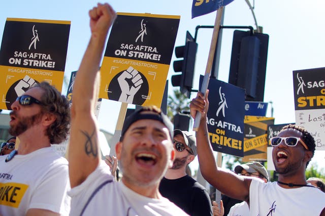 <p>Union power: Picketers chant outside Paramount Studios on day 118 of the Sag-Aftra strike</p>