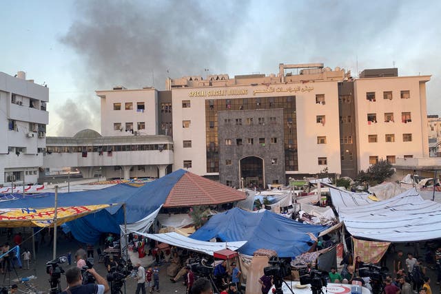 <p>Smoke rises as displaced Palestinians take shelter at Al Shifa hospital</p>