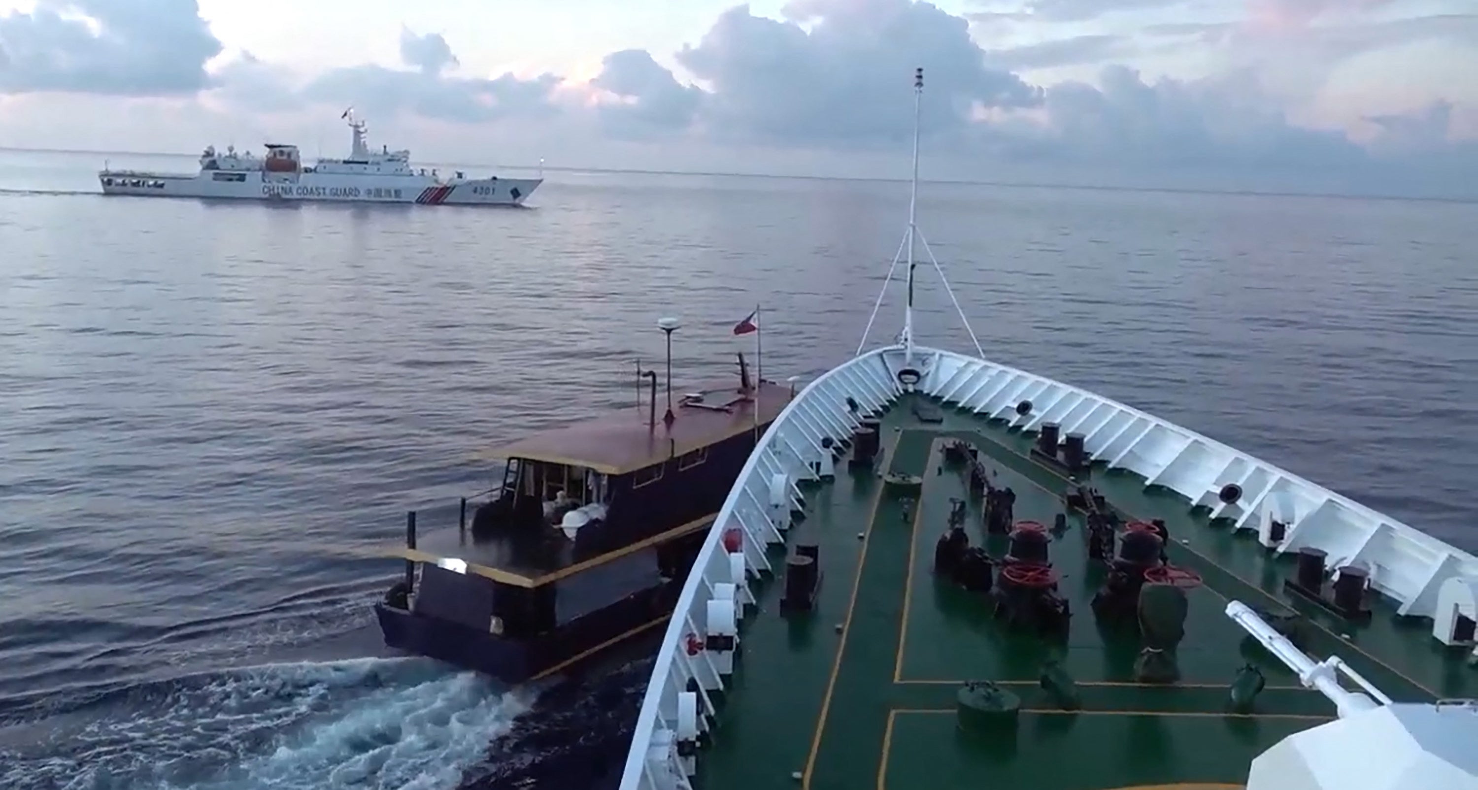 In this video grab taken from a video released by the Chinese Coast Guard (CCG) through the Chinese embassy in Manila on October 23, 2023 shows a collision between Chinese Coast Guard ship (R) and Philippines’ resupply boat (L) during a resupply mission in Second Thomas Shoal