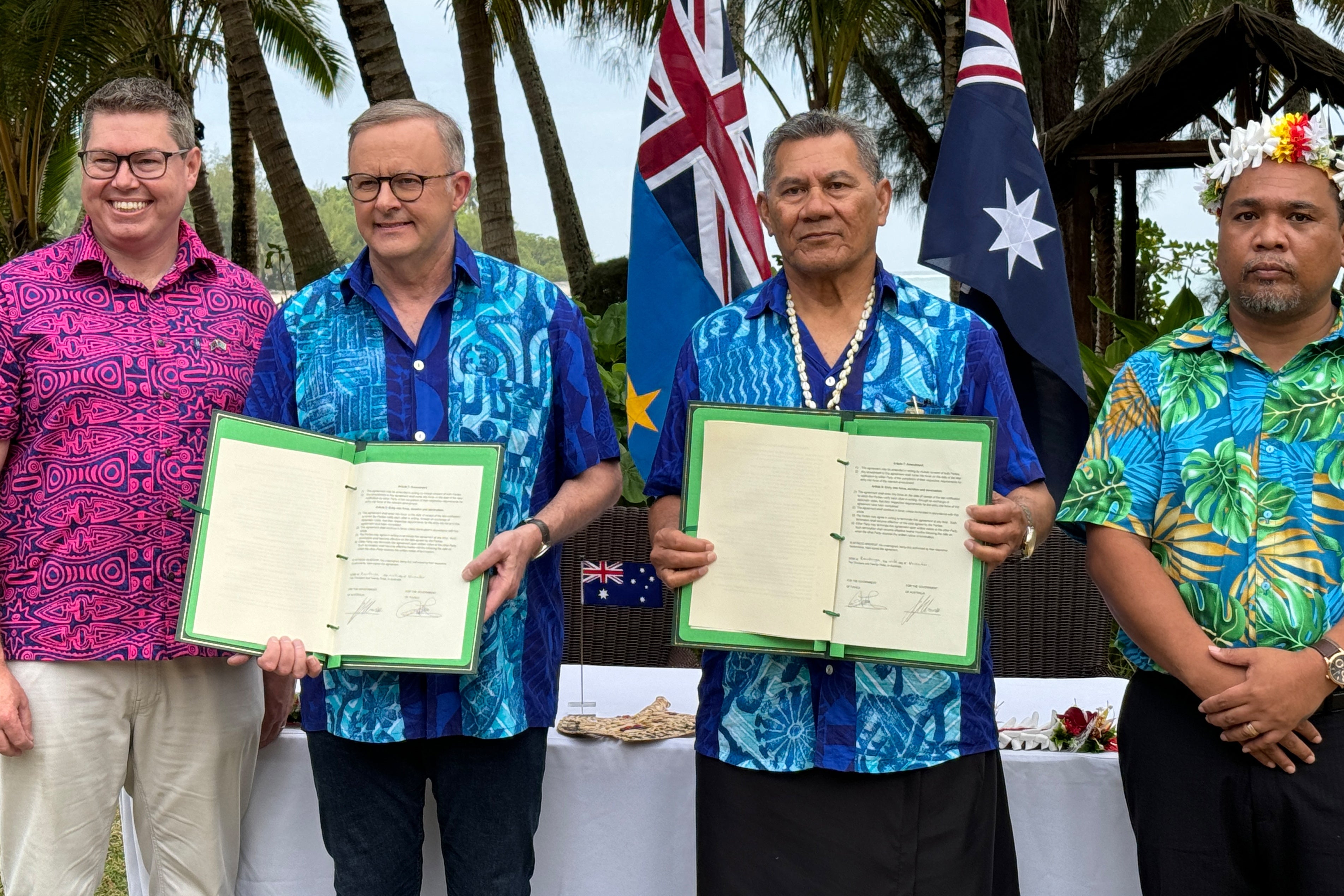 Australian Prime Minister Anthony Albanese and Tuvalu Prime Minister Kausea Natano display a compact between the two nations at the Pacific Resort, Rarotonga, the Cook Island
