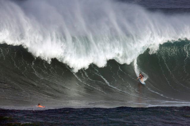 <p>A general photo of a competitior riding a wave at the Eddie Aikau Big Wave Invitational</p>