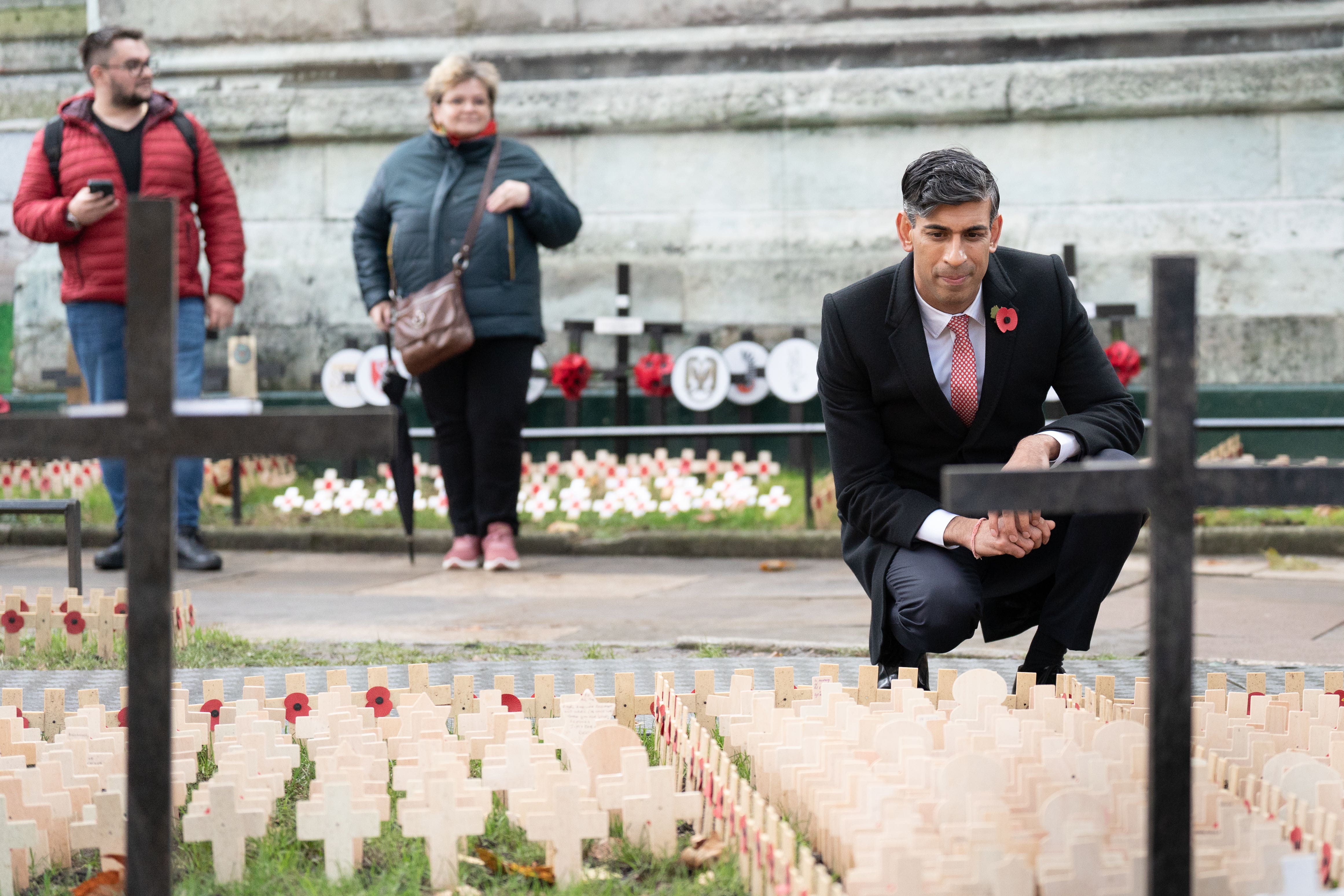 Prime Minister Rishi Sunak looks at the Remembrance Crosses (Stefan Rousseau/PA)