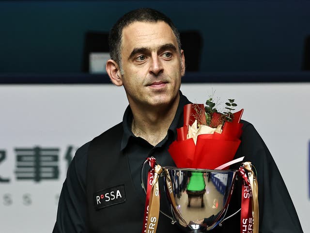 <p>Ronnie O'Sullivan of England holds the trophy after winning the final match against Luca Brecel</p>