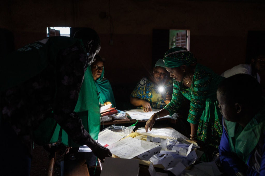 Election officials count the ballots in Mali’s referendum in Bamako on June 18, 2023, using the light from their cellphones. Mali often has electricity curtailment of up to eight hours a day