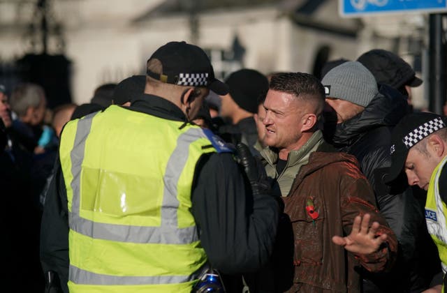 <p>Tommy Robinson talks to police at Cenotaph amid protests on Armistice Day </p>