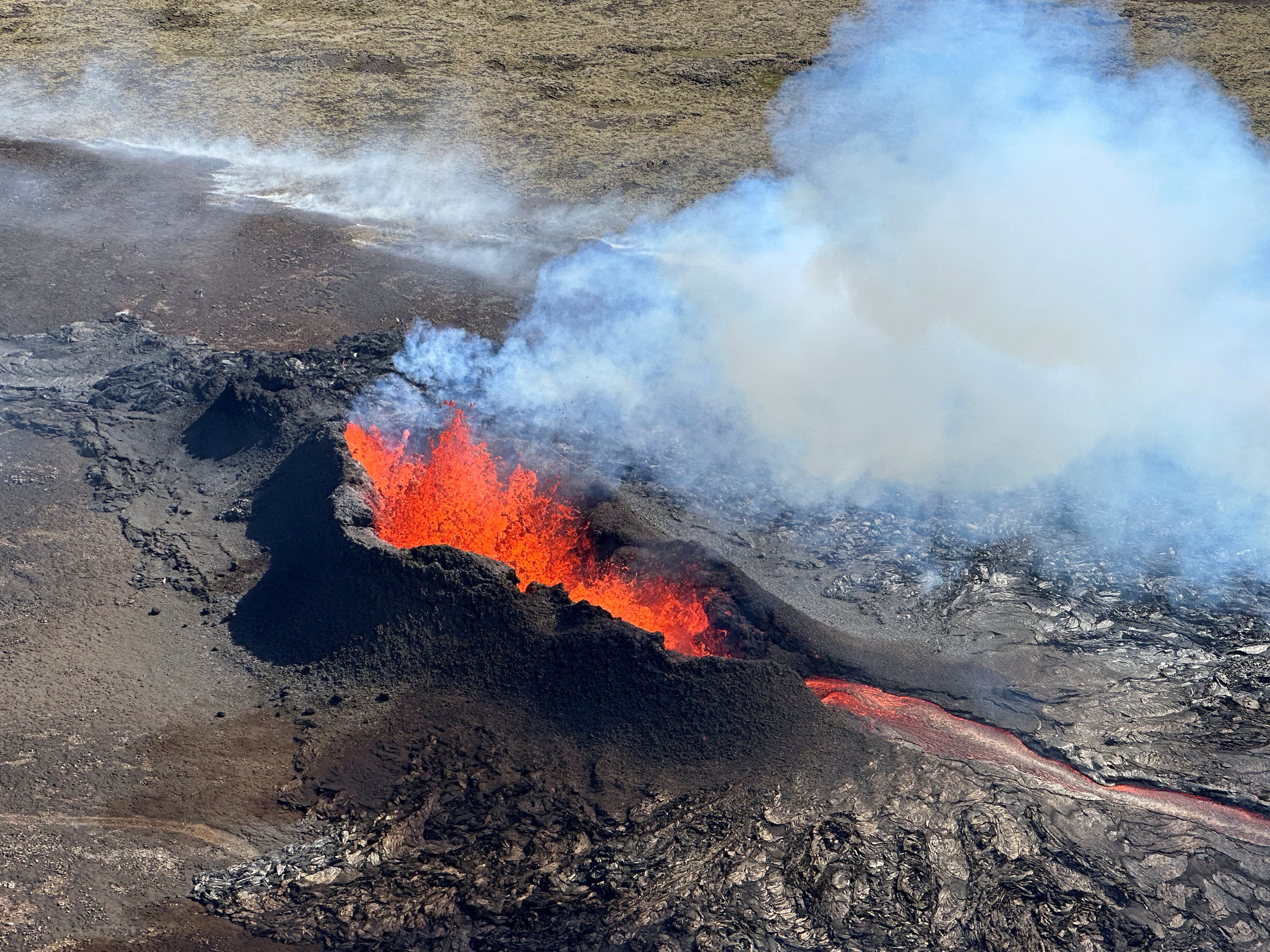 Lava spurts and flows after the eruption of a volcano on the Reykjanes peninsula in July