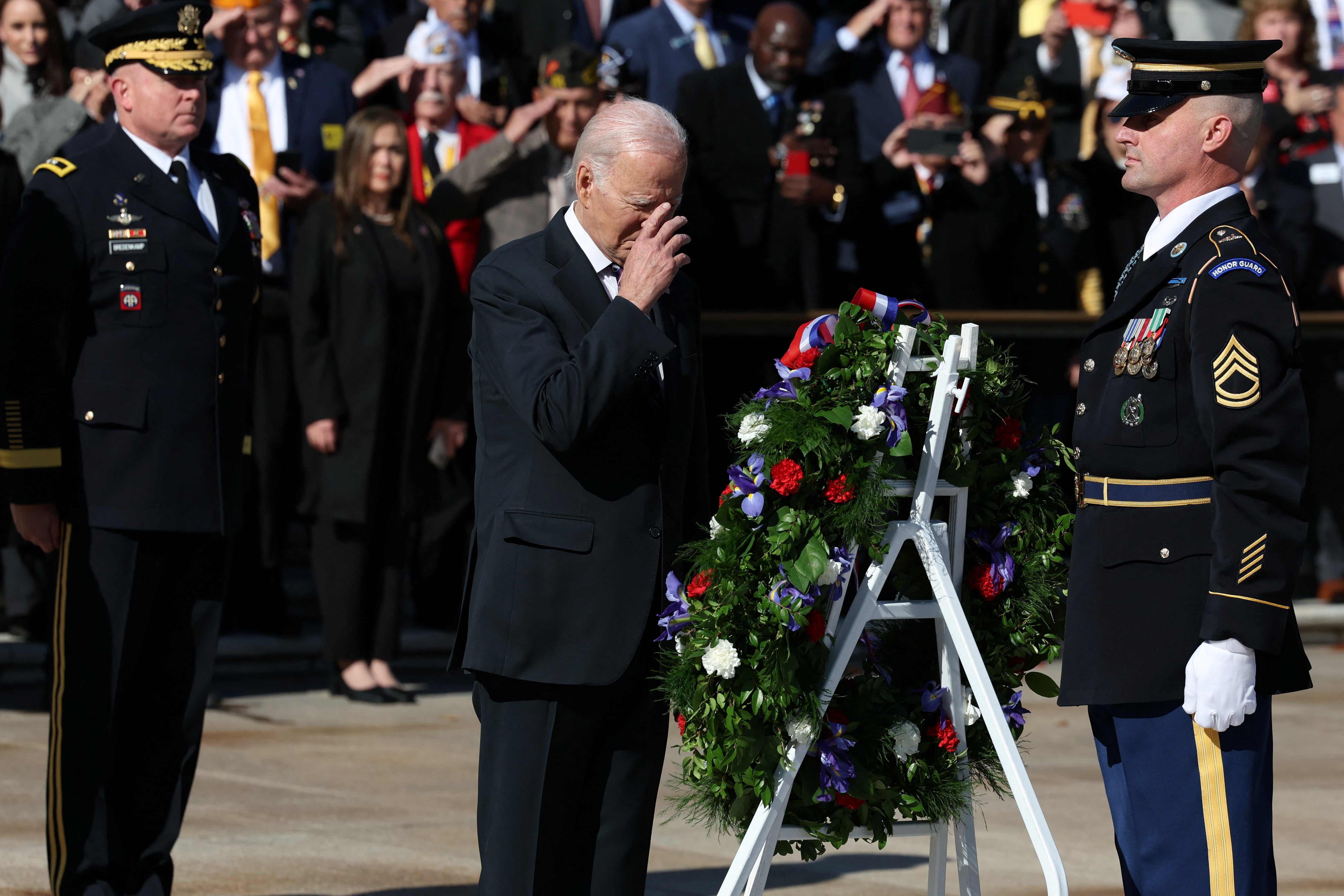 US President Joe Biden places a wreath while hosting veterans and members of the military community during a Veterans Day observance at the White House in Washington DC on 11 November