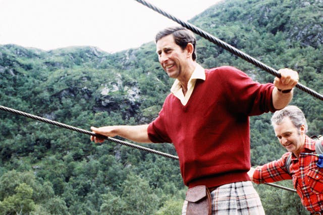 The then-Prince of Wales negotiating a two-inch wide wire bridge during a trek in the foothills of Ben Nevis with the Lochaber Mountain Rescue Team in 1987 (PA)
