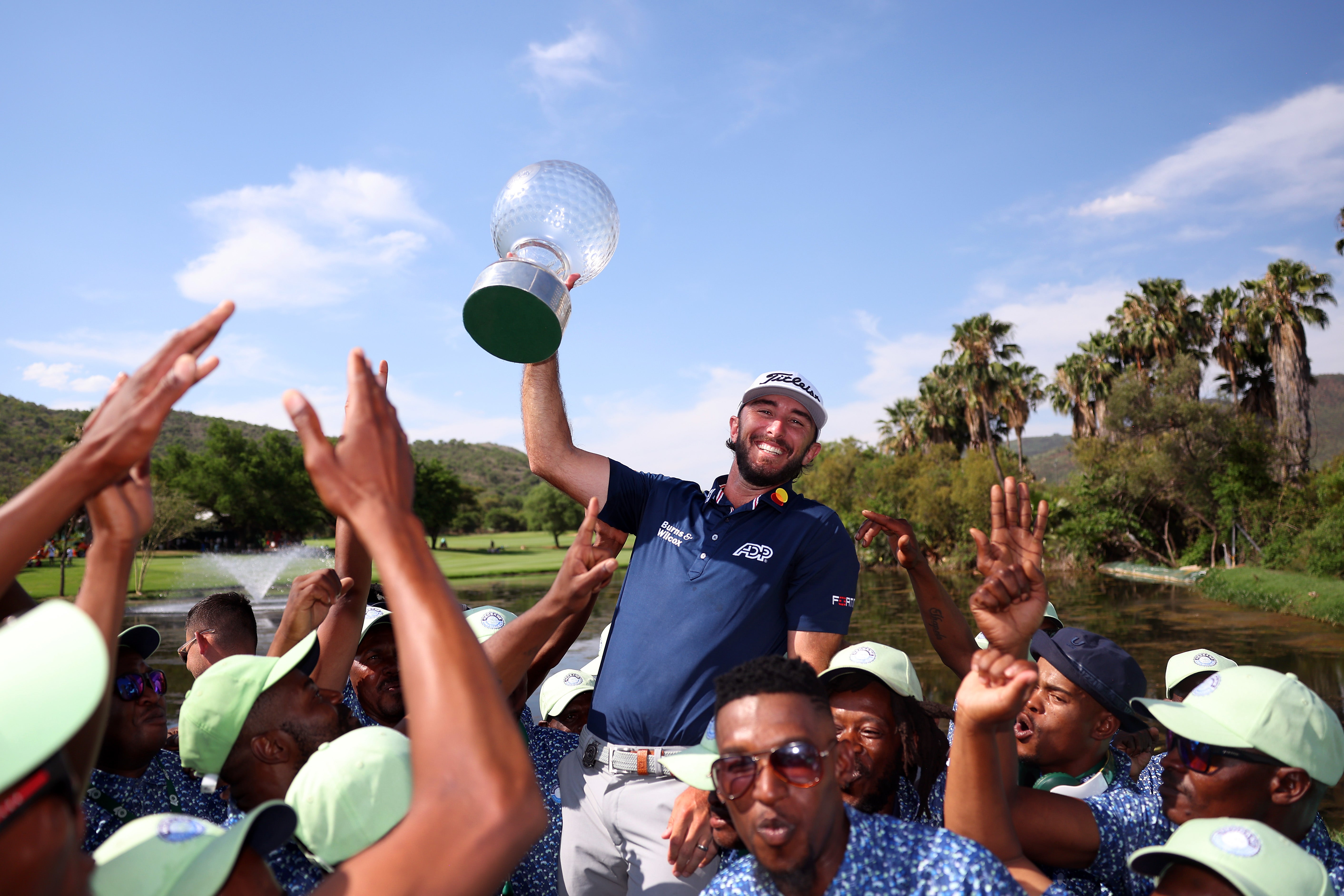 Max Homa of the United States holds the trophy as he celebrates victory at the Nedbank Golf Challenge
