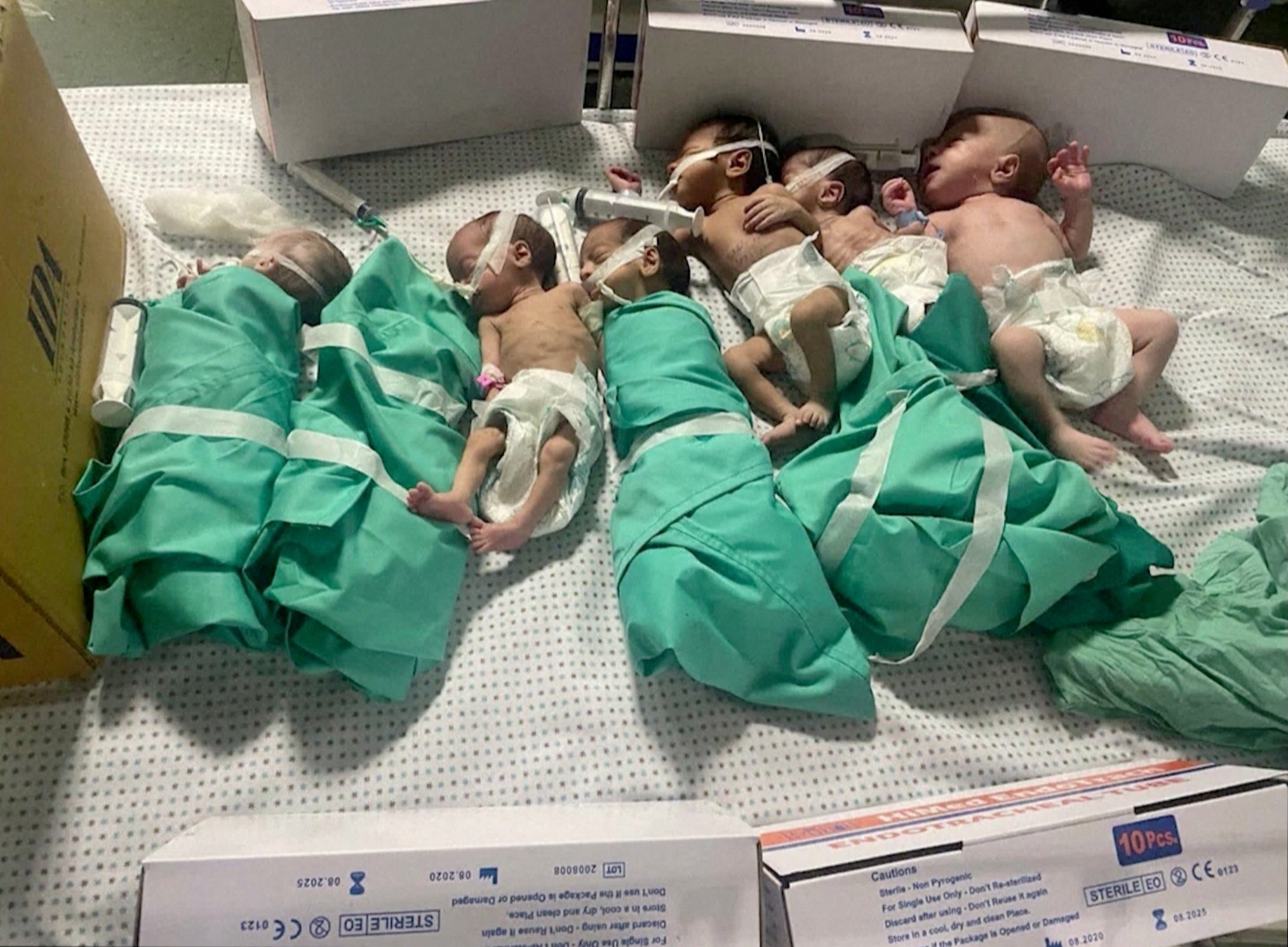 Newborns are placed in a bed after being taken from incubators at Gaza’s al-Shifa hospital during a power outage