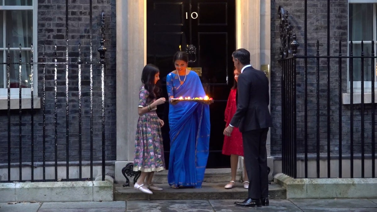 Rishi Sunak and his family light candles outside Downing Street for Diwali