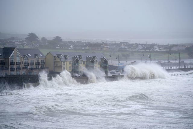 Waves at high tide in Tramore in County Waterford (Niall Carson/PA)