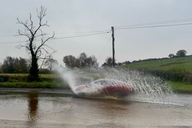 Cars struggled through flood water on roads surrounding Cookstown in Co Tyrone (Claudia Savage/PA)