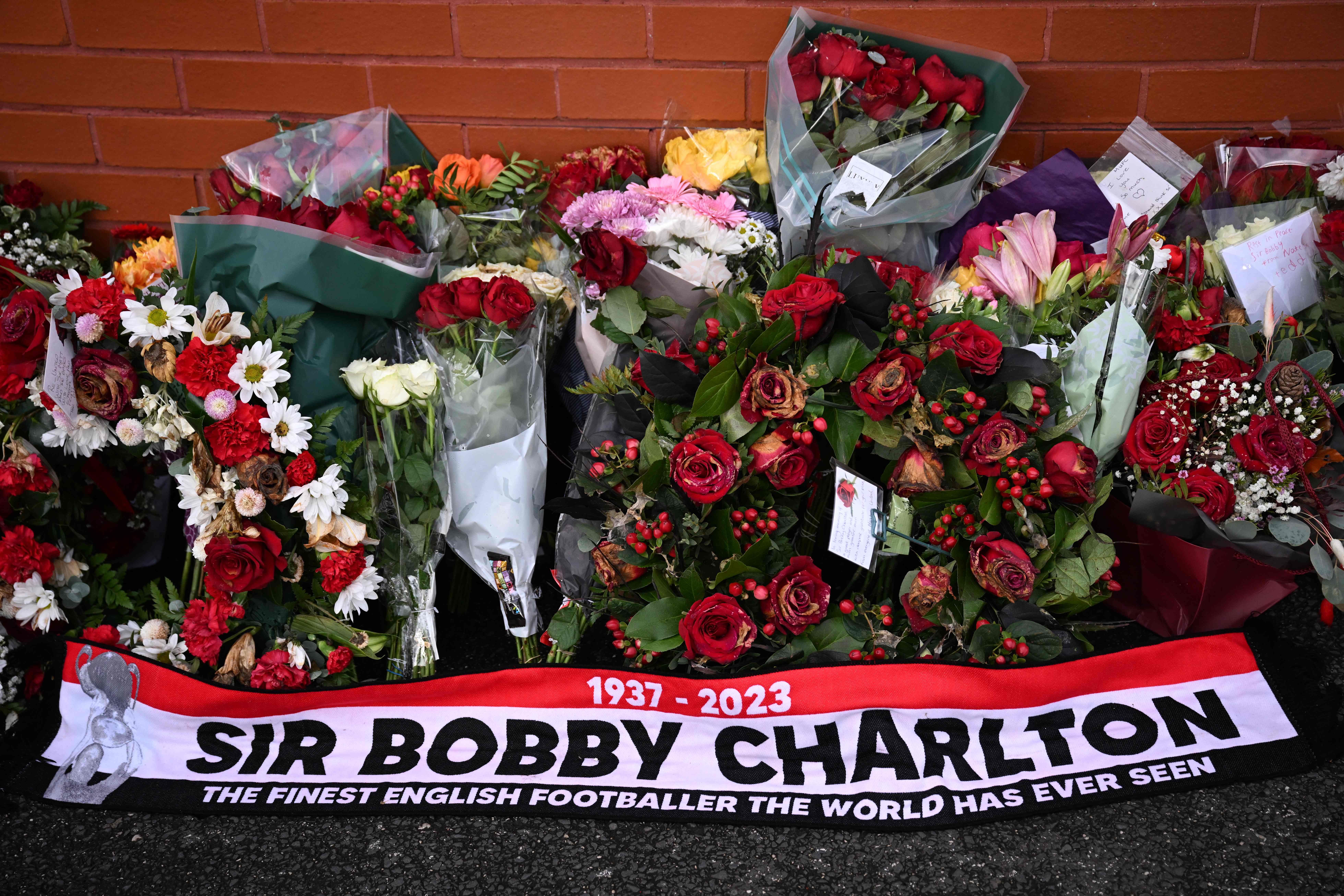 Flowers lie outside Old Trafford ahead of the memorial service