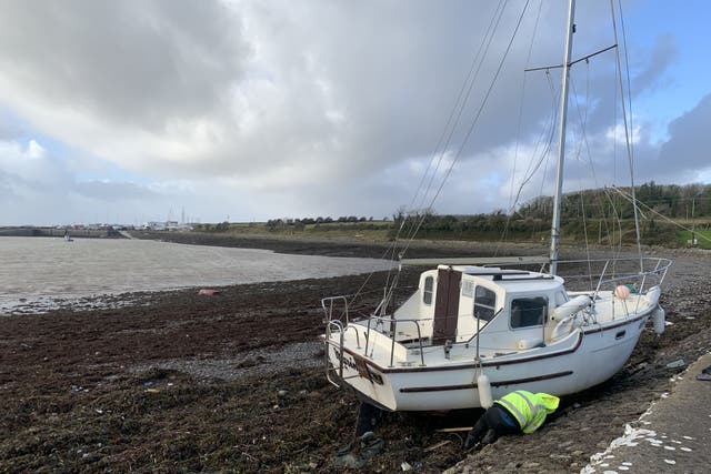 A boat washed off moorings at Galway Bay Sailing Club near Oranmore, Co Galway (Ed Carty/PA)