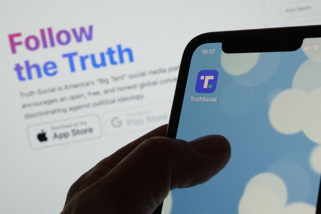 <p>Illustration photo shows Donald Trump’s new social media app Truth Social’s logo on a smartphone in Los Angeles, February 21, 2022.</p>