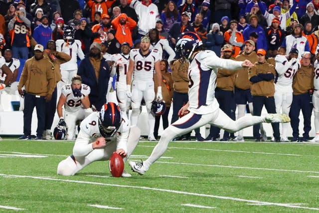 Denver Broncos place kicker Wil Lutz, right, kicks the winning field goal (Jeffrey T Barnes/AP)
