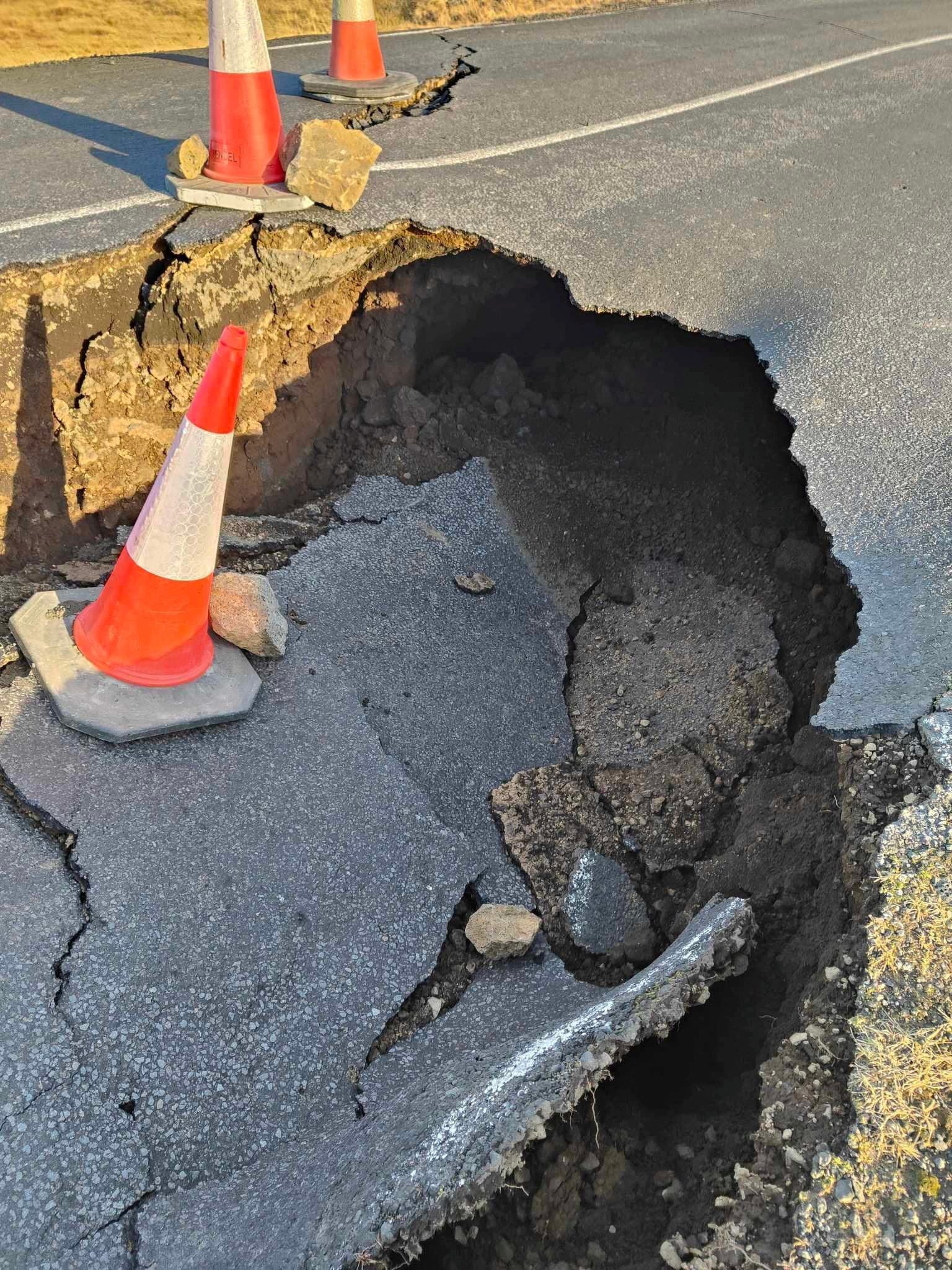 <p>A view of cracks, emerged on a road due to volcanic activity, near Grindavik, Iceland on 13 November 2023</p>