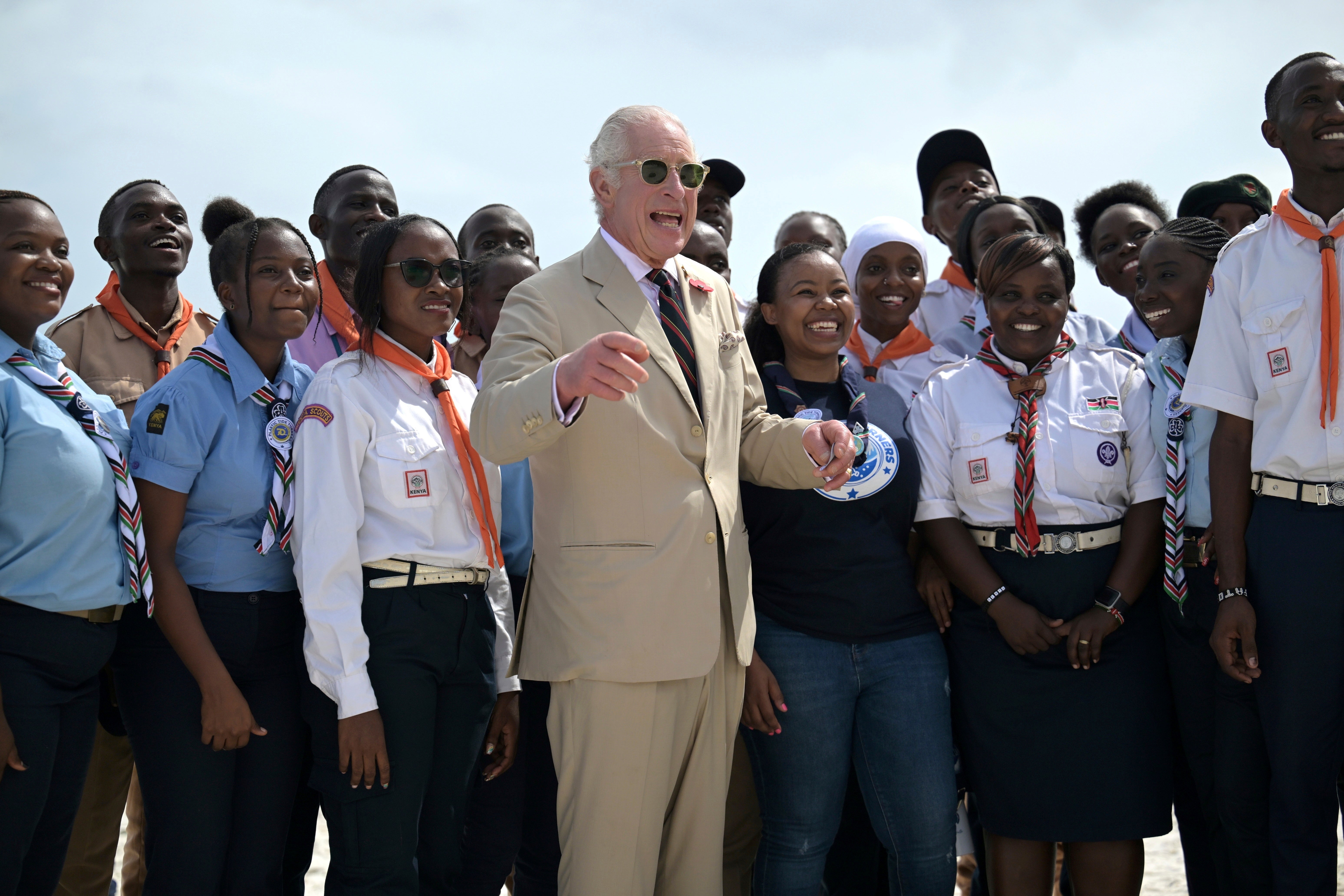 King Charles III, center gestures as he meets with Kenyan Scouts during a visit to Nyali beach in Mombasa, Kenya, Thursday, November 2, 2023