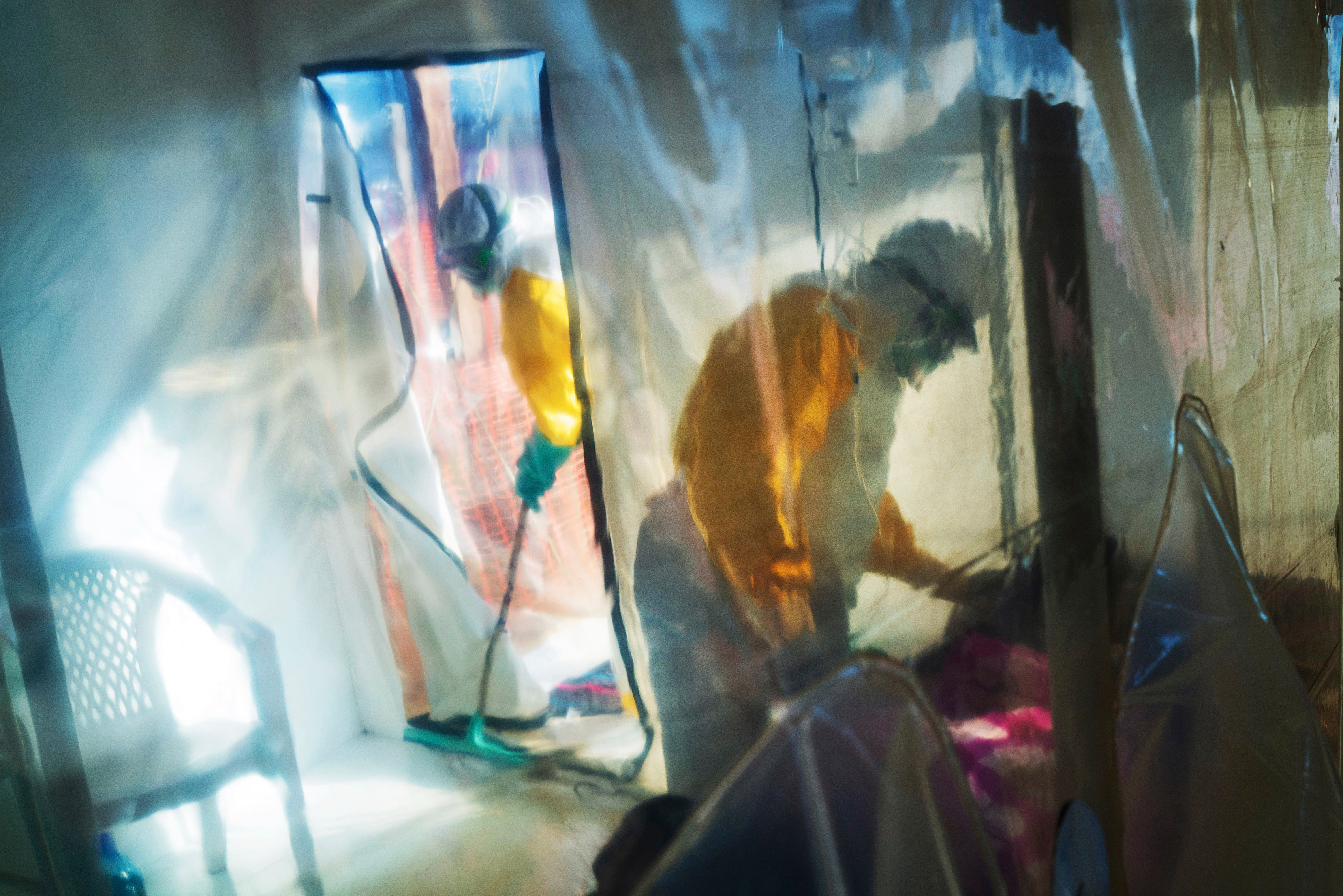 Health workers wearing protective suits tend to to an Ebola victim kept in an isolation tent in Beni, Democratic Republic of Congo, on Saturday, July 13, 2019