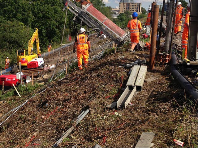 <p>Slip sliding away: Network Rail engineers work to prevent landslips (file photo)</p>