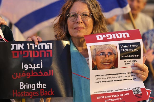 <p>A demonstrator holds a poster bearing the image of Israeli-Canadian Vivian Silver, held by Palestinian militants since the October 7 attack</p>