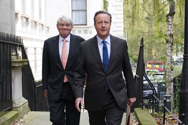 <p>Lord Cameron arrives in Downing Street – accompanied by international development secretary Andrew Mitchell – for his first Cabinet meeting as foreign secretary </p>