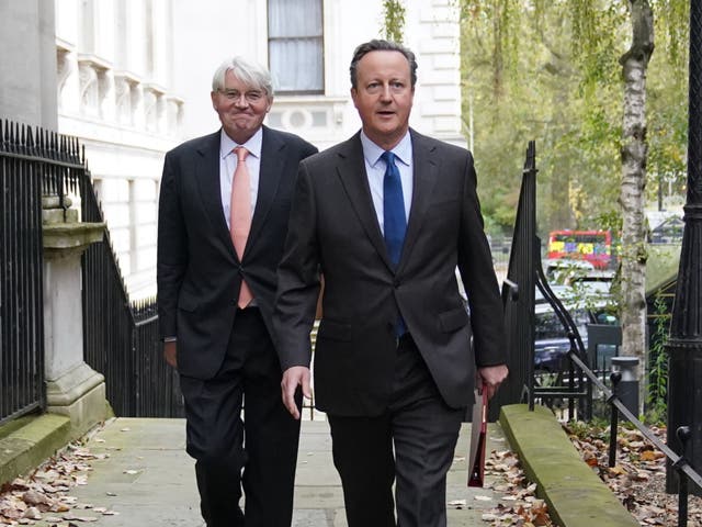 <p>Lord Cameron arrives in Downing Street – accompanied by international development secretary Andrew Mitchell – for his first Cabinet meeting as foreign secretary </p>