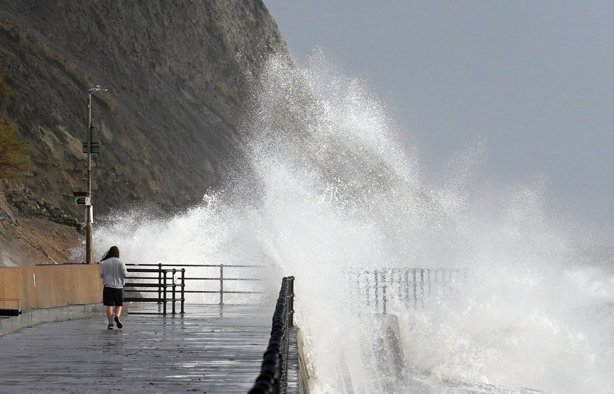 Waves crash over the promenade in Folkestone, Kent as Storm Debi hits the UK