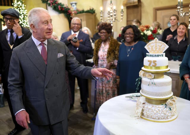 <p>King Charles III next to a birthday cake during his 75th birthday party at Highgrove Gardens</p>