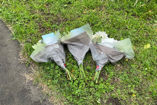 Floral tributes left on behalf of a school for three children killed in a house fire in Channel Close, Hounslow (George Lithgow/PA)