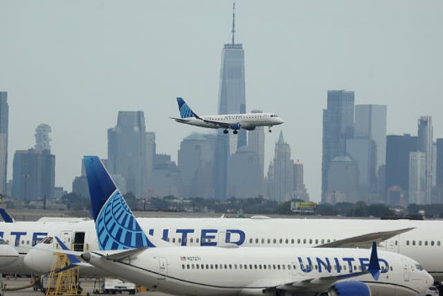 <p> A United Airlines plane lands at Newark Liberty International Airport in front of the New York skyline on September 17, 2023 in Newark, New Jersey</p>