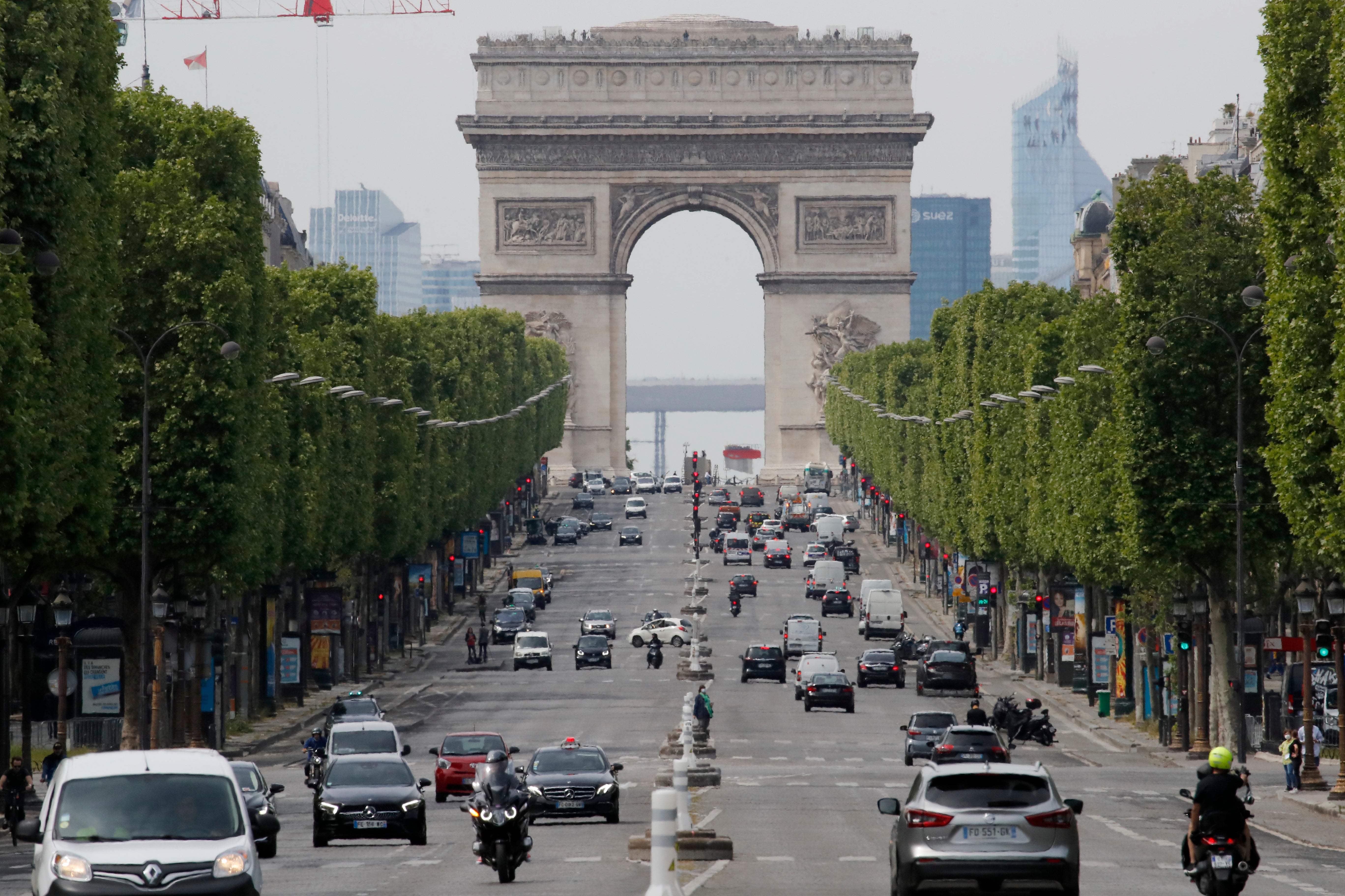 <p> Cars drive on the Champs Elysee avenue</p>
