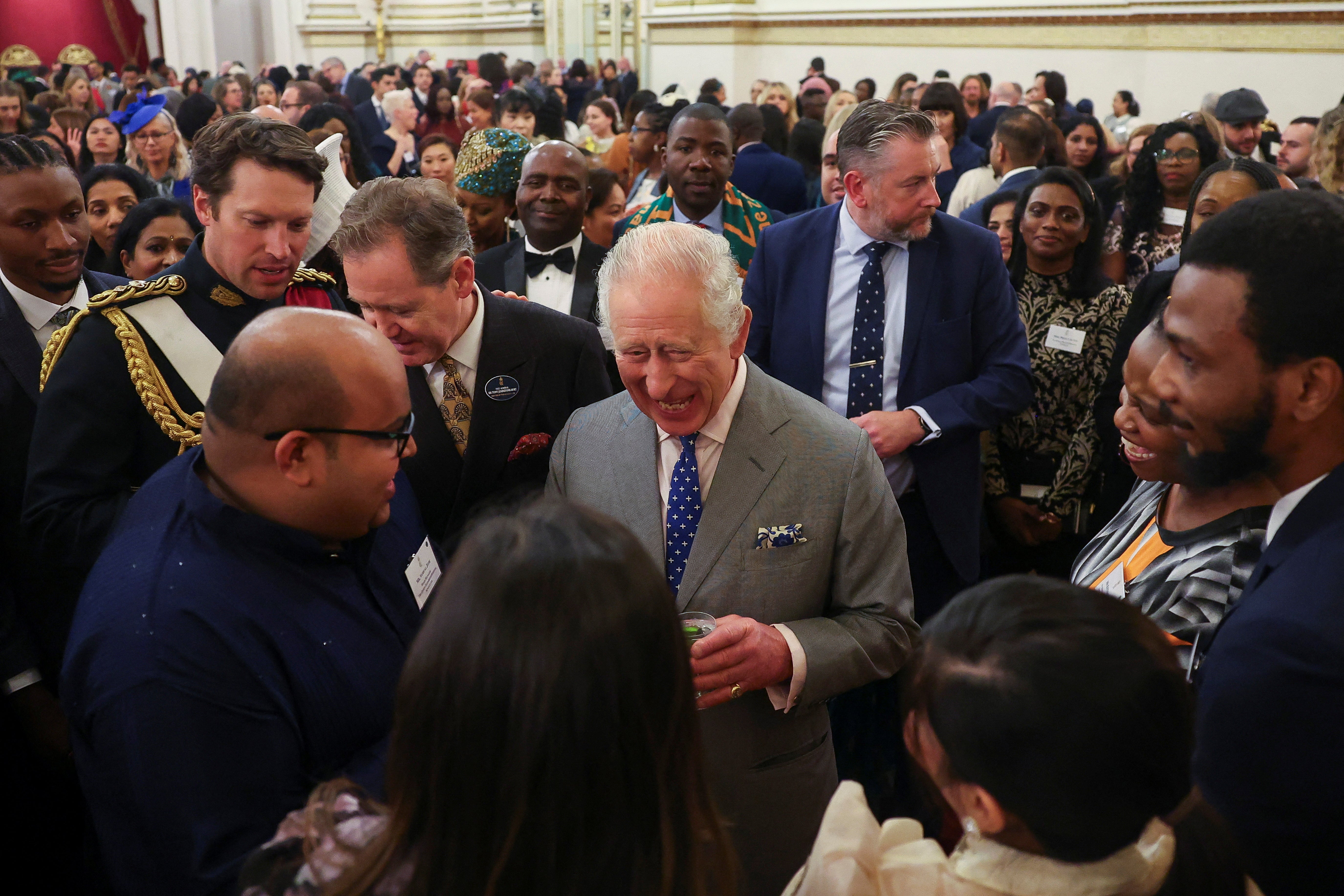 King Charles III speaks with guests during a reception on his 75th birthday to celebrate nurses and midwives working in the UK, as part of the NHS 75 celebrations, at Buckingham Palace