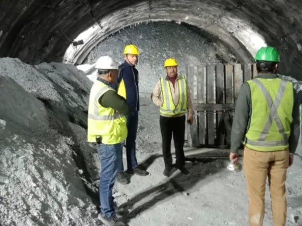 <p>This photo provided by Uttarakhand State Disaster Response Force (SDRF) shows rescuers and others inside a collapsed road tunnel where 40 workers were trapped in northern in Uttarakhand state, India, Tuesday, 14 November 2023 </p>