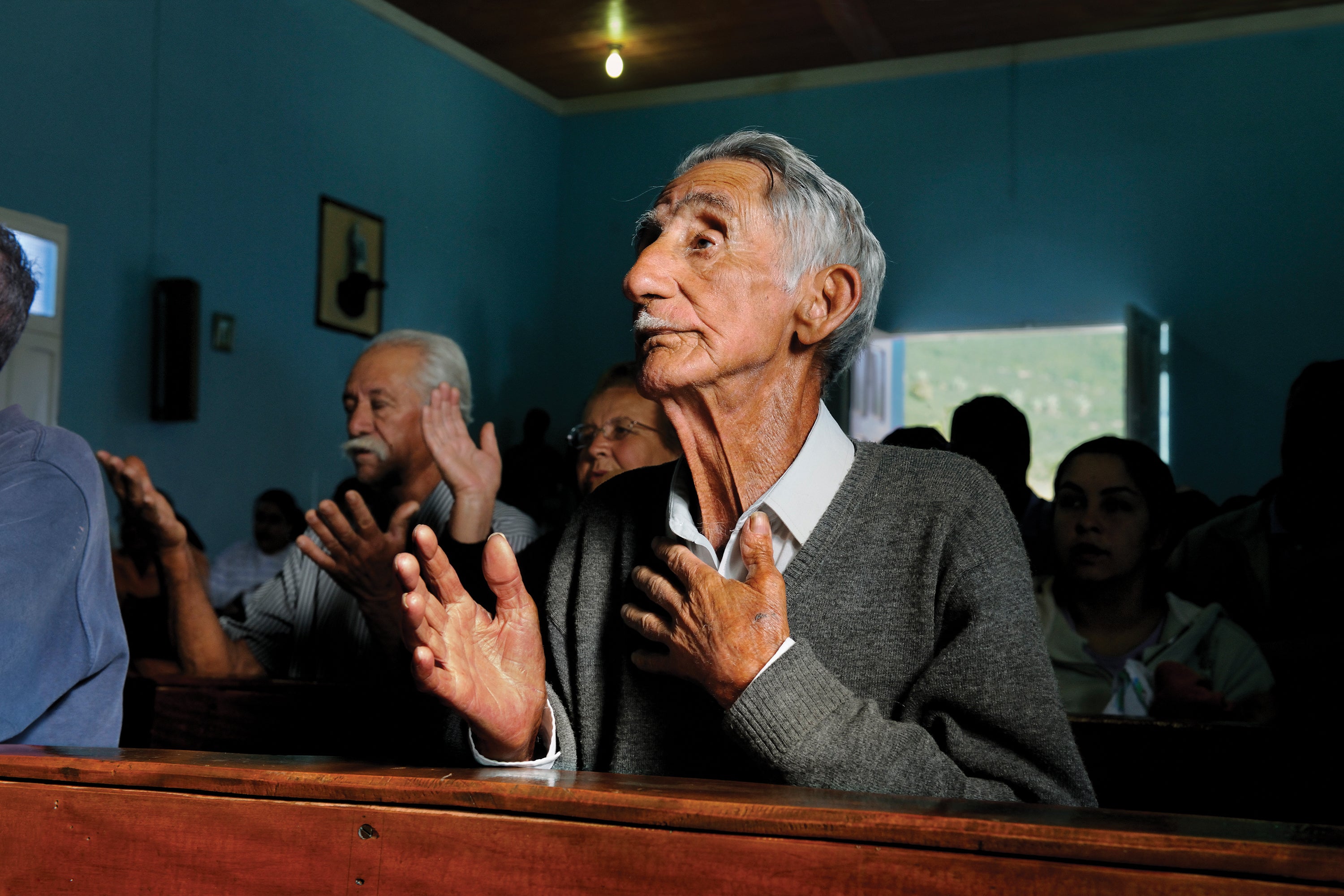 A man prays in church in Lavazza, Brazil