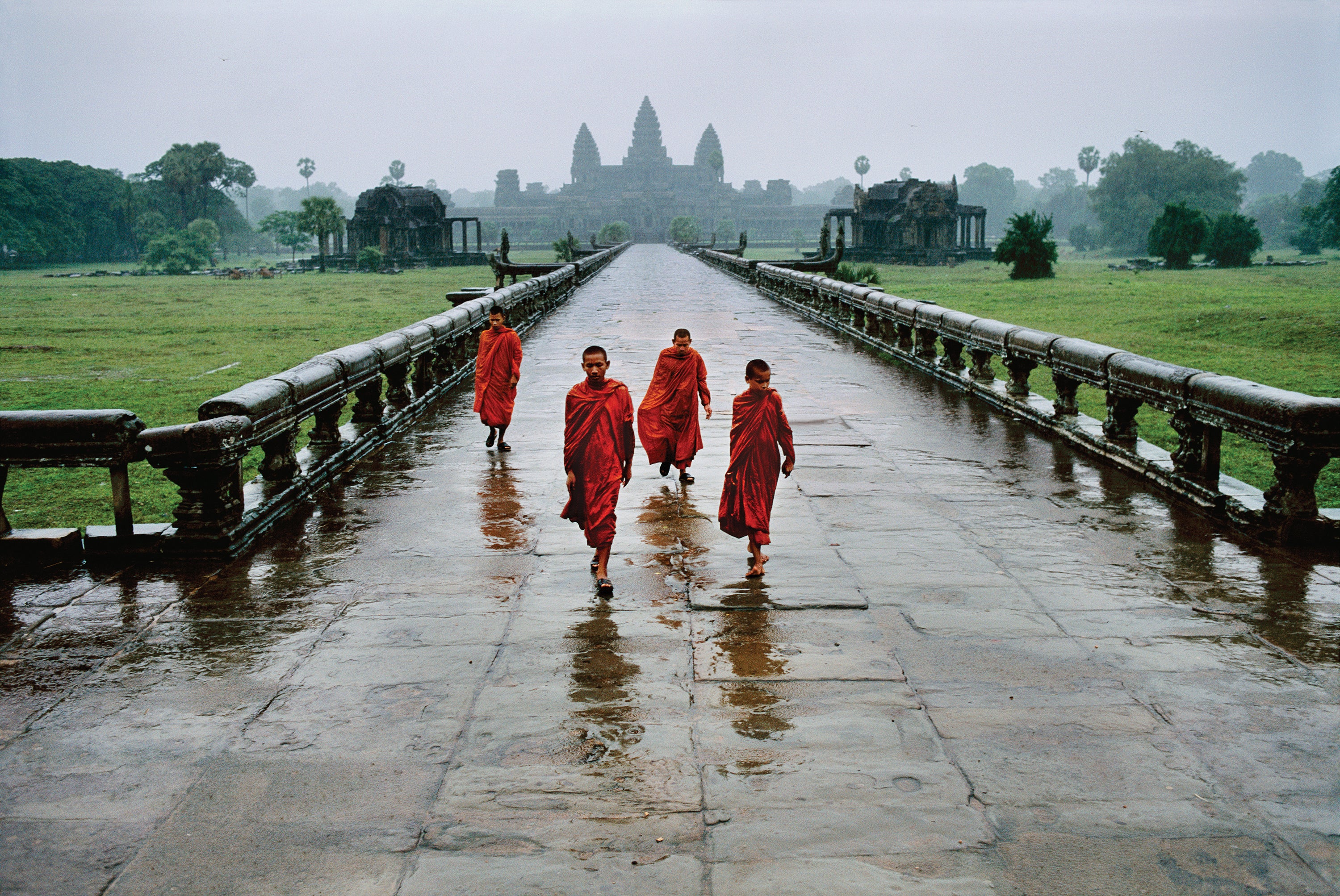 The formal properties of this image are subtle but remarkably successful. The four monks are walking in the rain along the Naga causeway at Angkor Wat, Cambodia. The ordered balance of space and colour between the monks works in harmony with the receding perspective to connect them to the temple in the distance