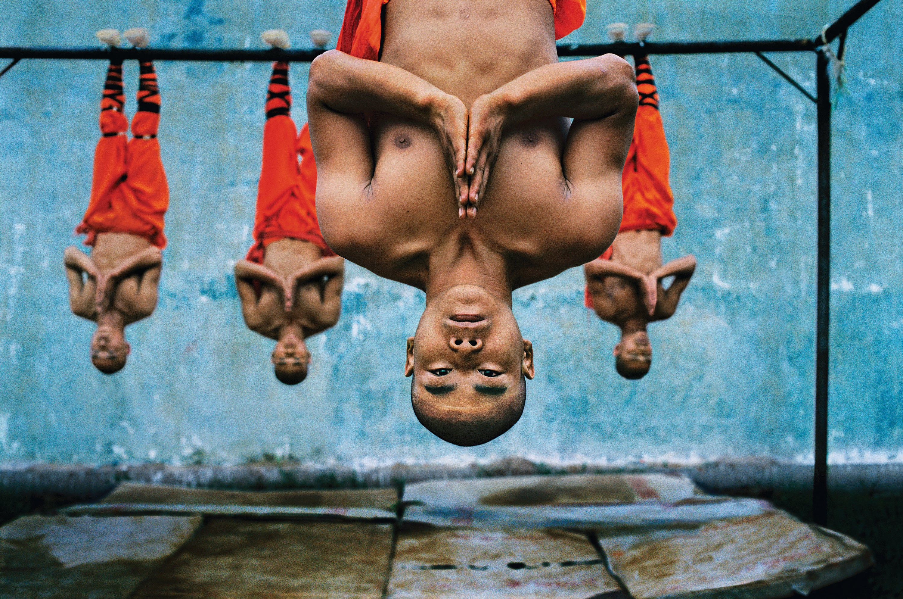 Monks suspend themselves from a metal beam as they train at the Shaolin Monastery in Zhengzhou, China. The physical strength and dexterity displayed by the monks is incredible, although they exude a deep serenity
