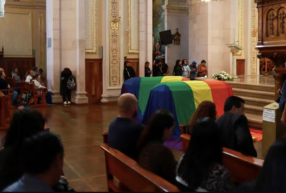 Coffins were draped with the LGBT flag at the funeral