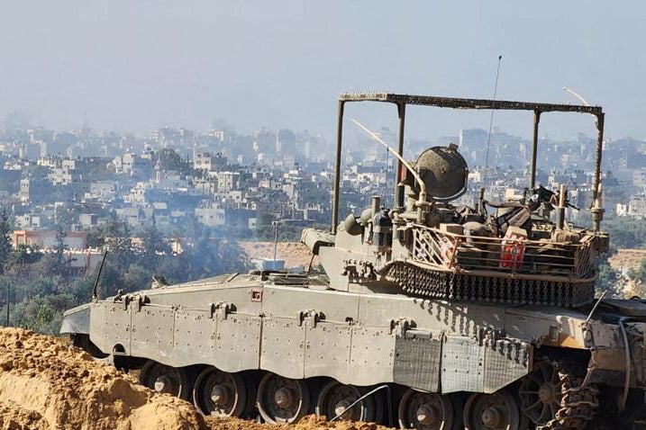 Israeli soldiers on an armed vehicle during a military operation around Al-Shifa hospital in Gaza City