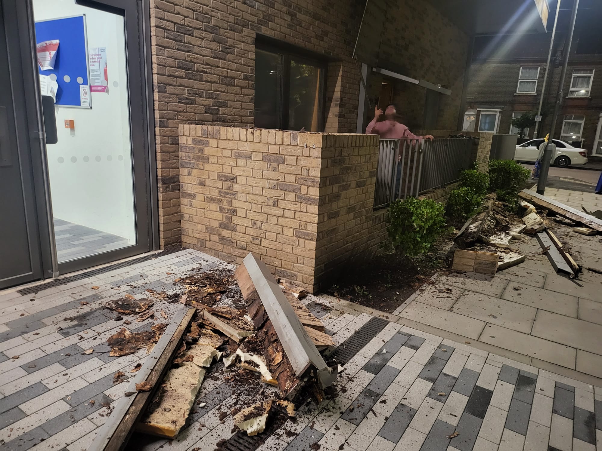 Pieces of metal and rotted wood were seen in pieces outside the apartment complex entrance