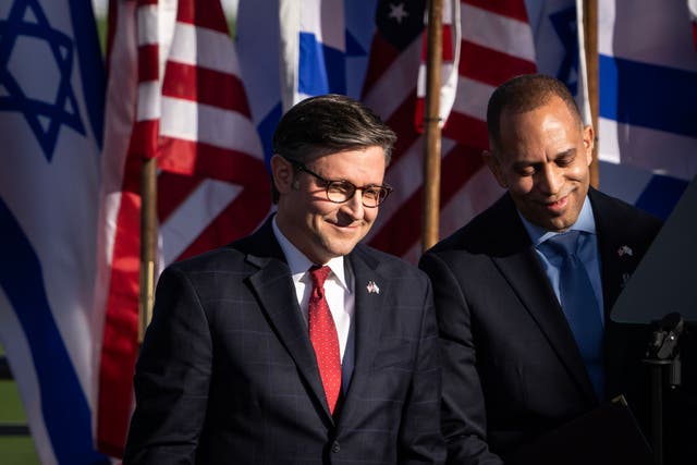 <p>Speaker of the House Mike Johnson (R-LA) and House Minority Leader Hakeem Jeffries (D-NY) talk while waiting to speak during the March for Israel on the National Mall November 14, 2023 in Washington, DC.</p>