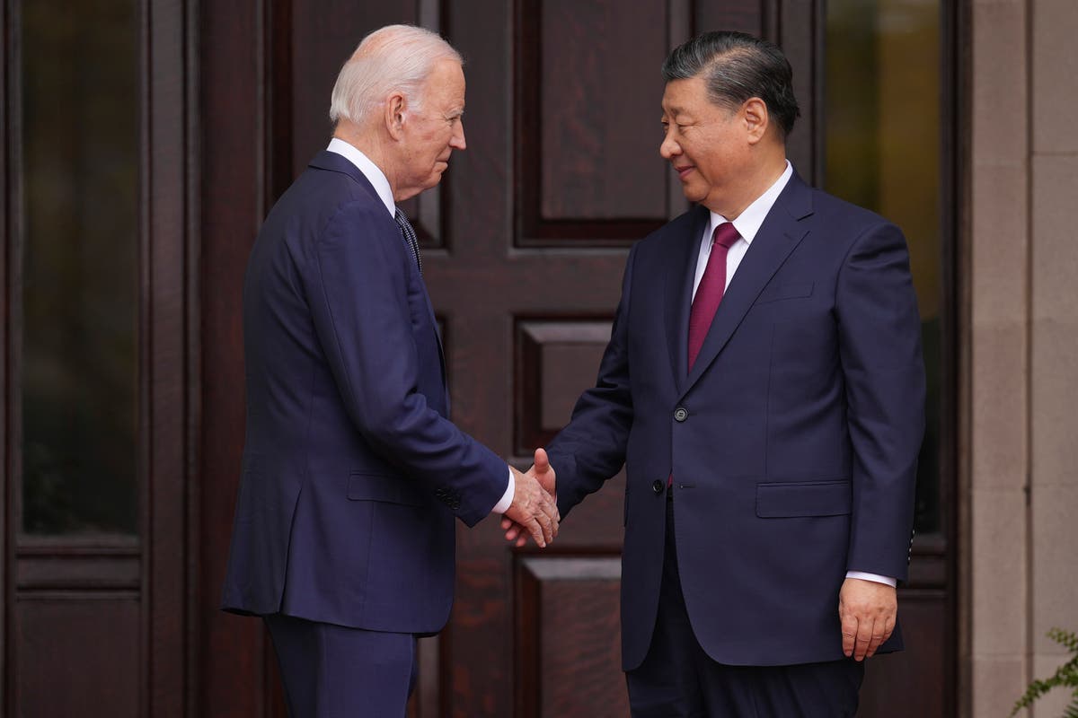 Biden and Xi greet each other with a warm handshake on the sidelines of ...