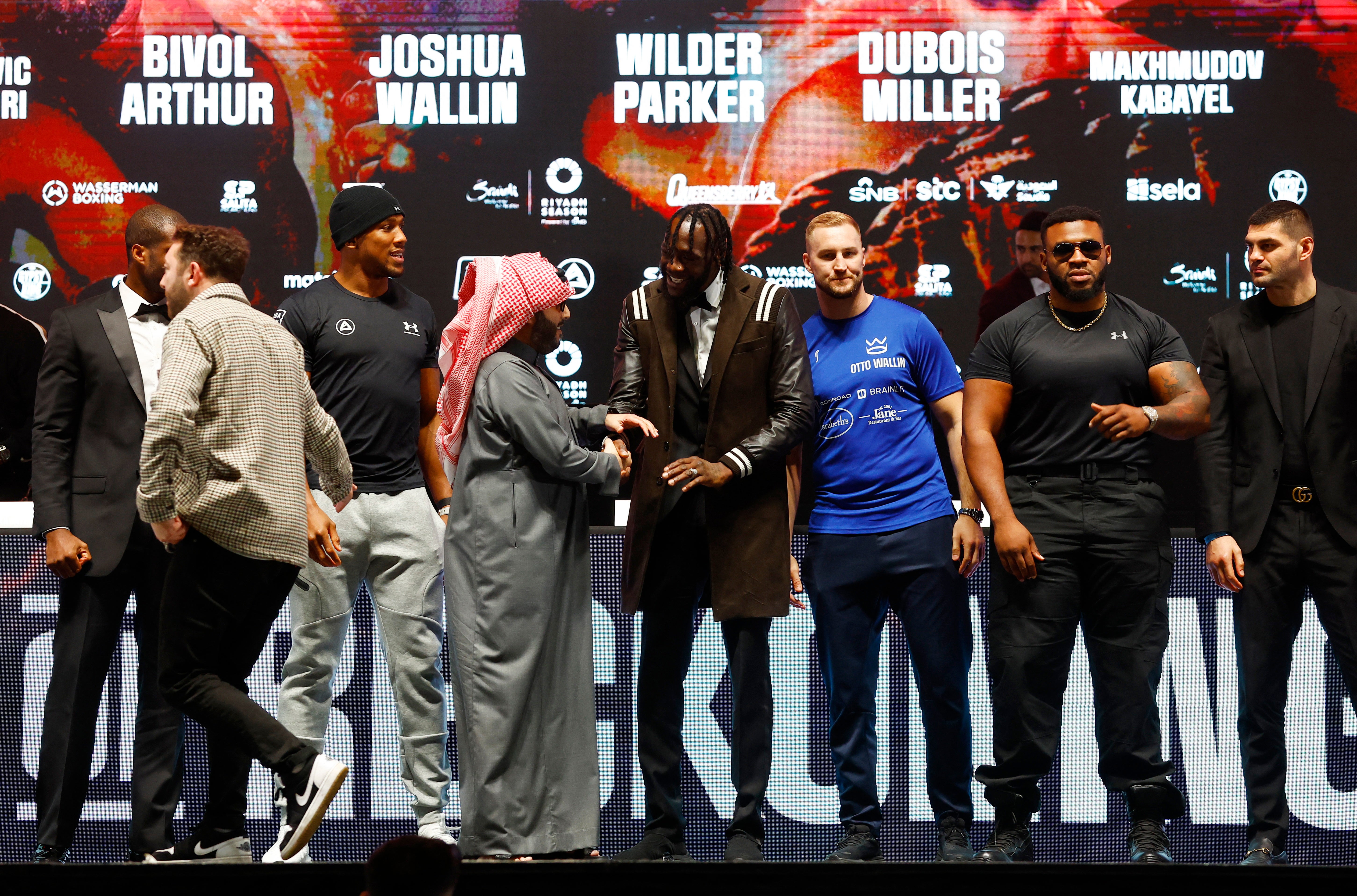Joshua and Wilder are greeted by Saudi adviser Turki Alalshikh, while standing alongside fellow heavyweights