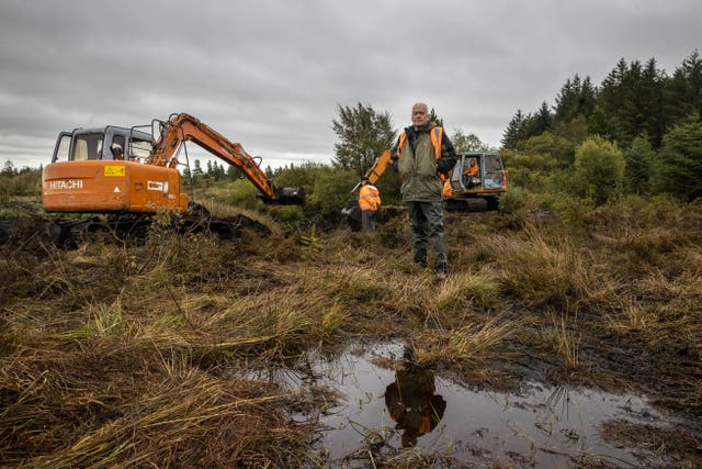 Jon Hill, of the Independent Commission for the Location of Victims’ Remains, stands besides excavators at Bragan bog in Co Monaghan (Liam McBurney/PA)