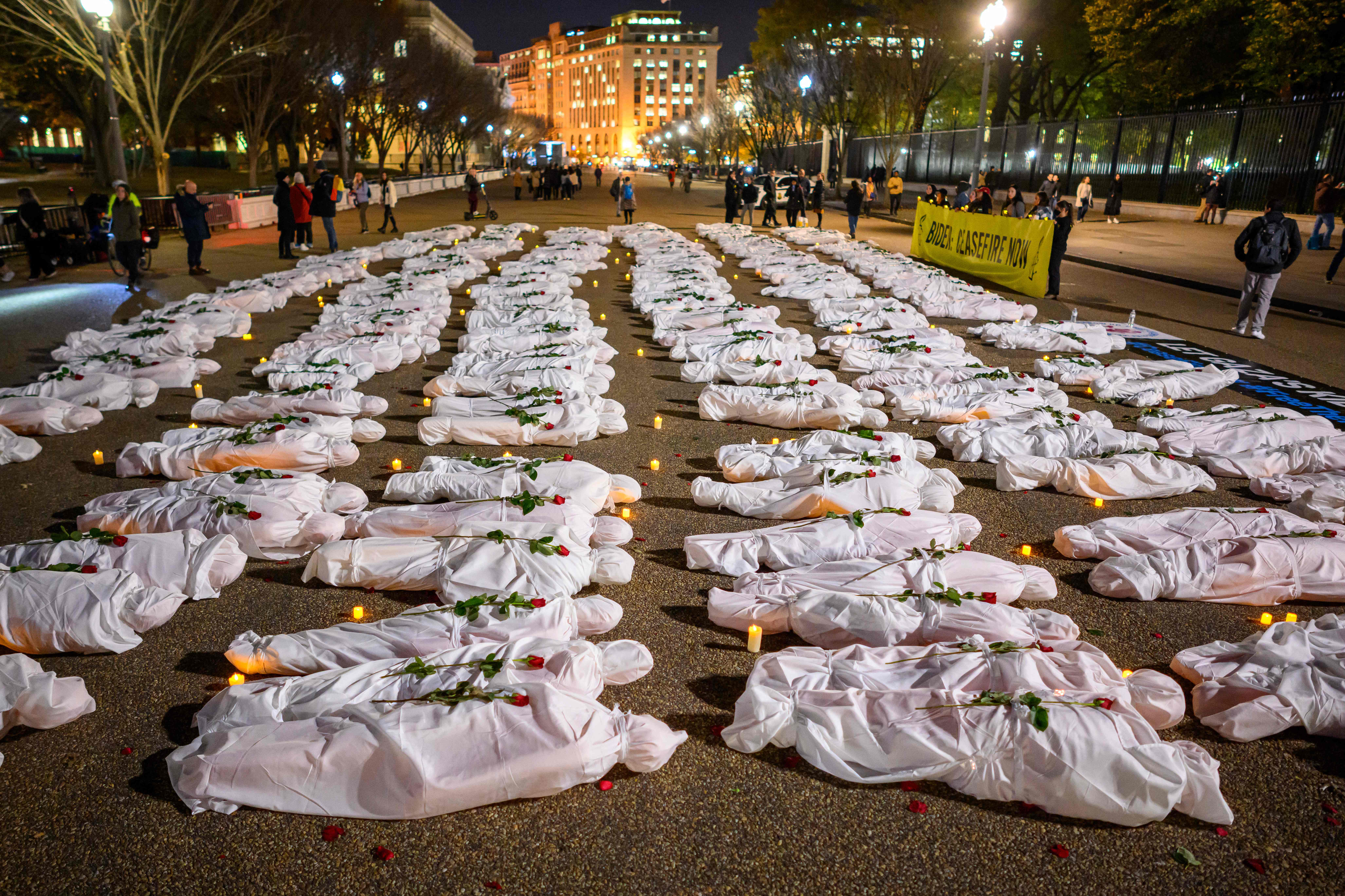White-shrouded body bags representing victims in the Israel-Hamas conflict, are seen during a vigil in front of the White House in Washington, DC,
